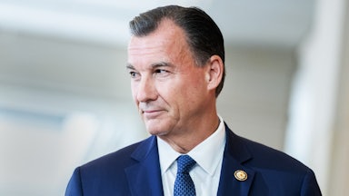 Representative Tom Suozzi looks to the side