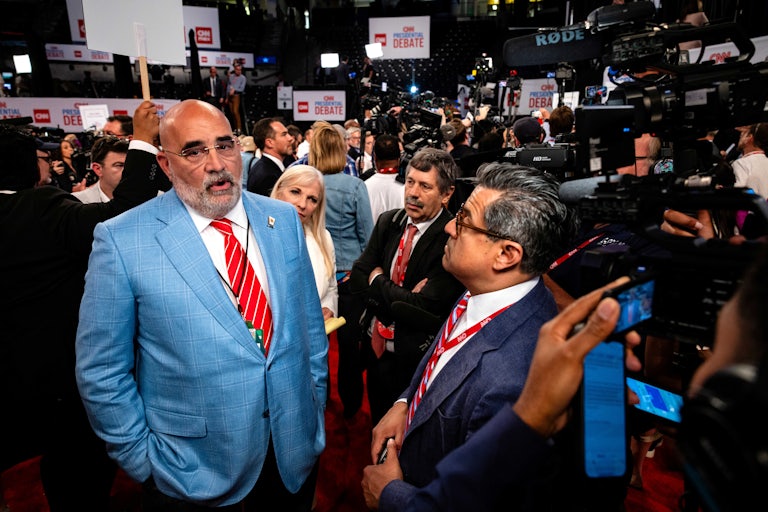 Trump campaign manager Chris LaCivita speaks to reporters surrounding him