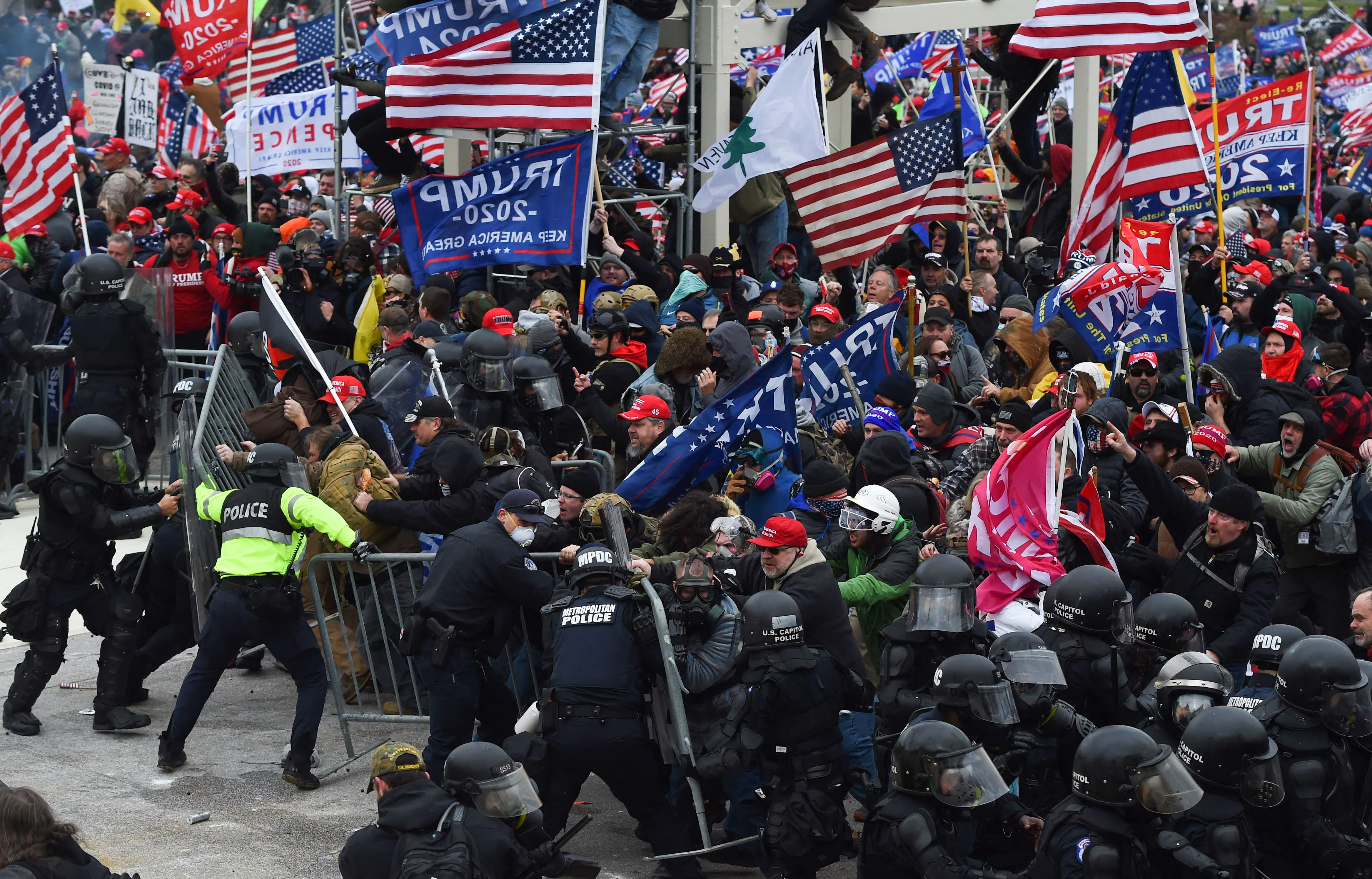A large crowd of Trump supporters clash with police and security forces as they attempt to take down a barricade to storm the Capitol on January 6, 2021.
