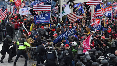 A large crowd of Trump supporters clash with police and security forces as they attempt to take down a barricade to storm the Capitol on January 6, 2021.