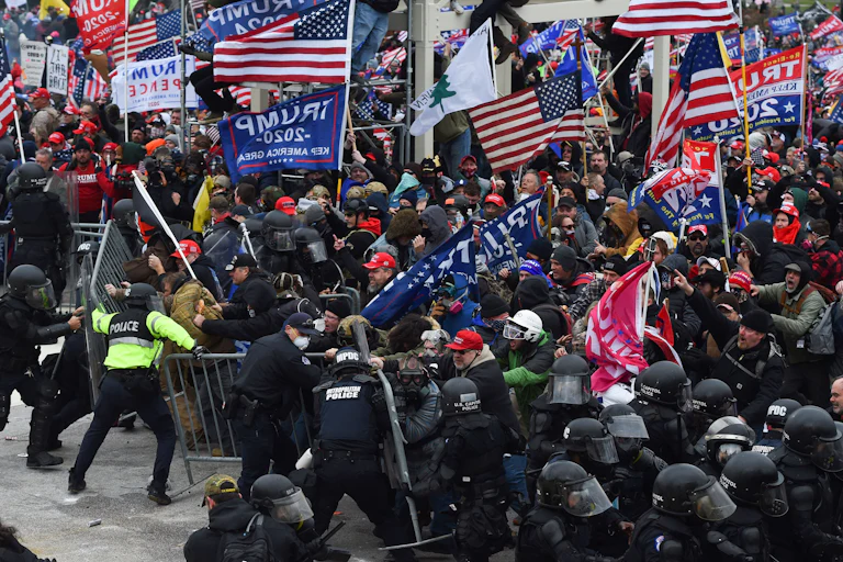 A large crowd of Trump supporters clash with police and security forces as they attempt to take down a barricade to storm the Capitol on January 6, 2021.