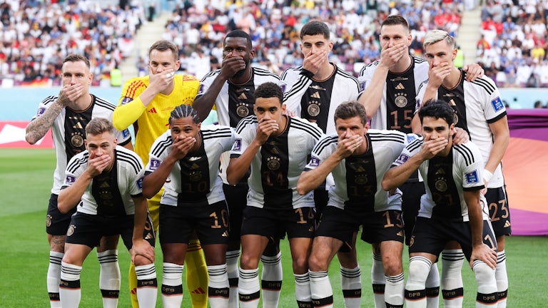 German team players cover their mouths with their hands
