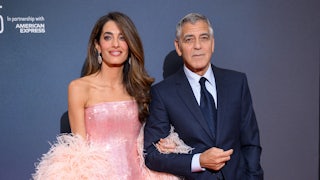 Amal Clooney and George Clooney dressed up on a red carpet