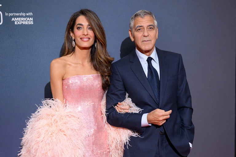 Amal Clooney and George Clooney dressed up on a red carpet