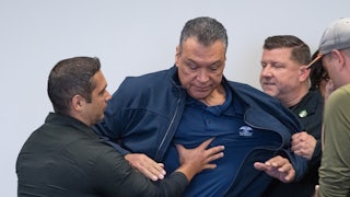 California Senator Alex Padilla is pushed out of the room