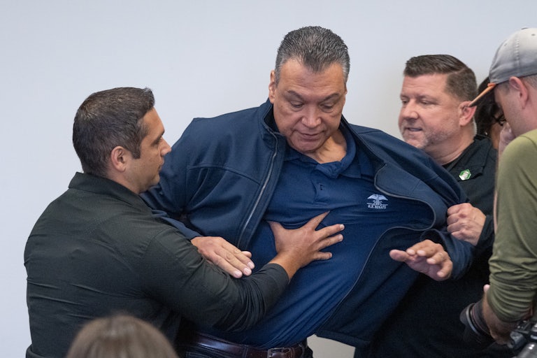California Senator Alex Padilla is pushed out of the room