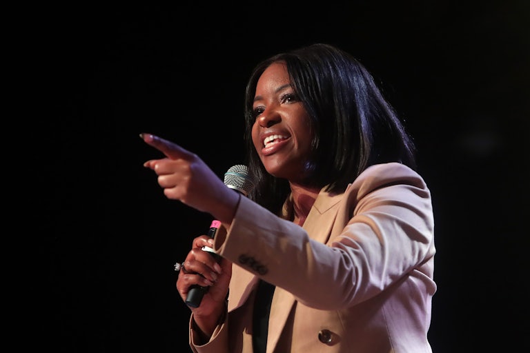 Jasmine Crockett speaks on a microphone and points her finger.