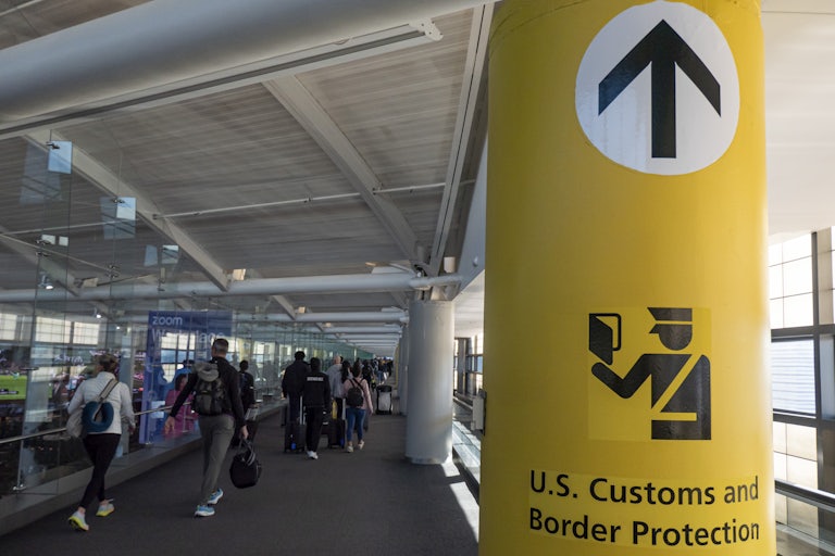 A column in an aiport directs passengers to U.S. Customs and Border Protection.