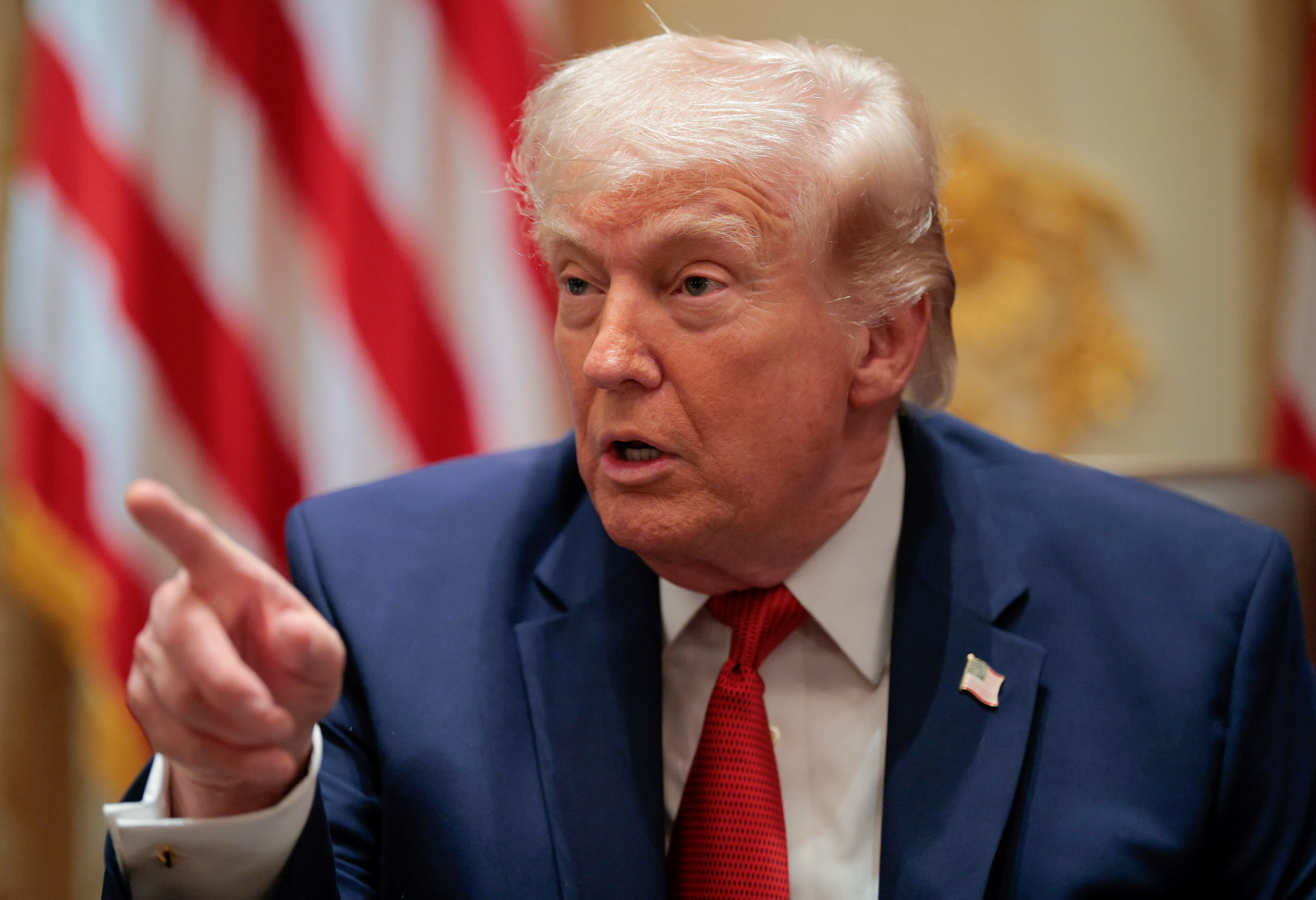 President Donald Trump points while speaking