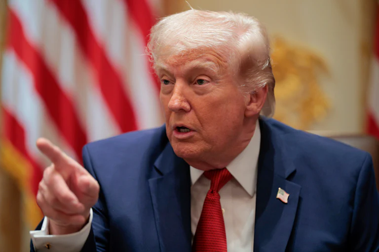 President Donald Trump points while speaking