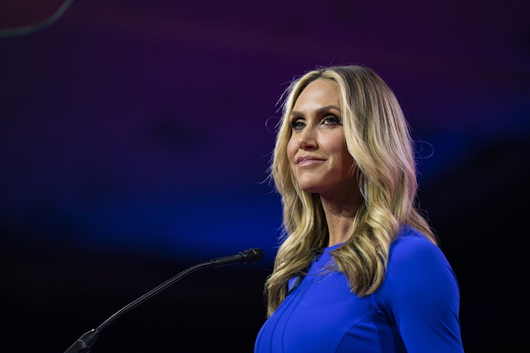 Lara Trump stands in front of a microphone