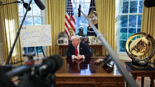 Donald Trump speaks to the press after signing an executive order in the Oval Office of the White House.