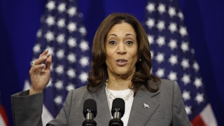 Kamala Harris speaks at a podium with American flags behind her.