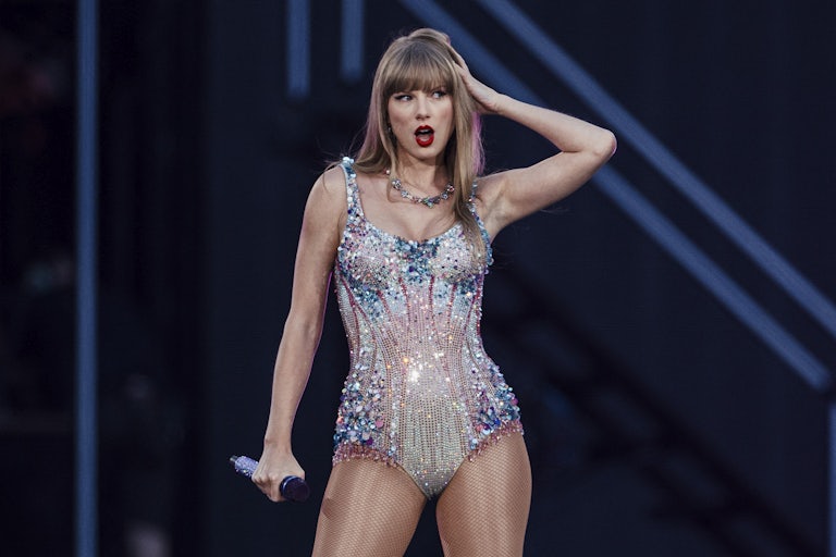 Taylor Swift touches her hair