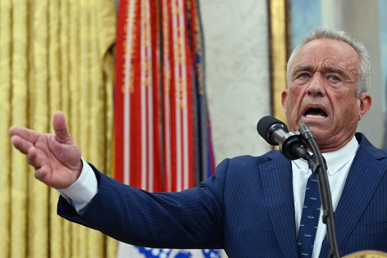 Robert F. Kennedy Jr. gestures while speaking into a microphone in the Oval Office