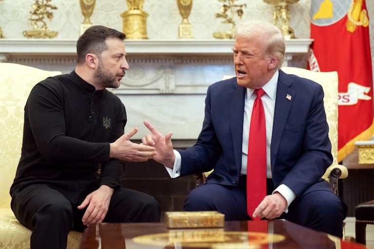 Donald Trump raises his finger and speaks as he and Ukrainian President Volodymyr Zelenskiy sit in the Oval Office