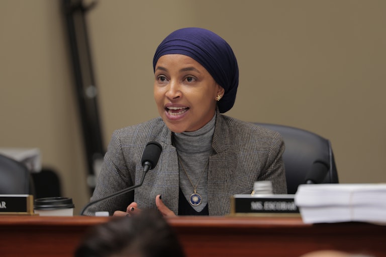 Representative Ilhan Omar speaks into a microphone during a House hearing