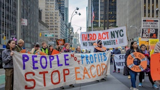 Activists hold signs reading "People not Profits" and "Third Act NYC."