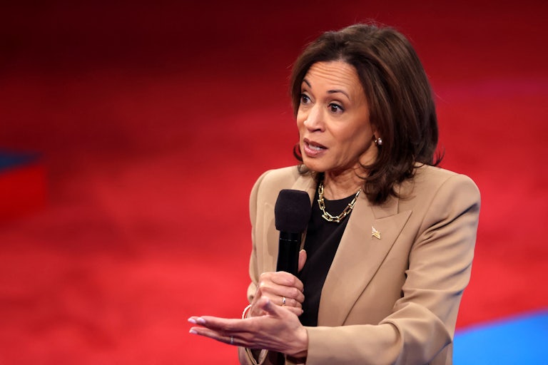 Kamala Harris holds a microphone and speaks during a town hall hosted by Univision
