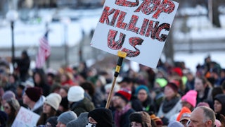 People gather in front of the Minnesota State Capitol during a demonstration over the fatal shooting of Renee Good.
