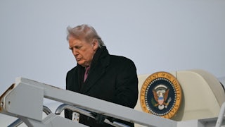 Donald Trump looks down while disembarking from Air Force One