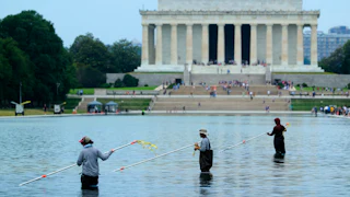National Park Service employees and contractors use vacuums to remove green algae from the bottom of the Lincoln Memorial Reflecting Pool. The NPS is working to control and remove the algae bloom that has turned the pool green following the Trump Administration’s recent $14 million repair, resealing and painting project.