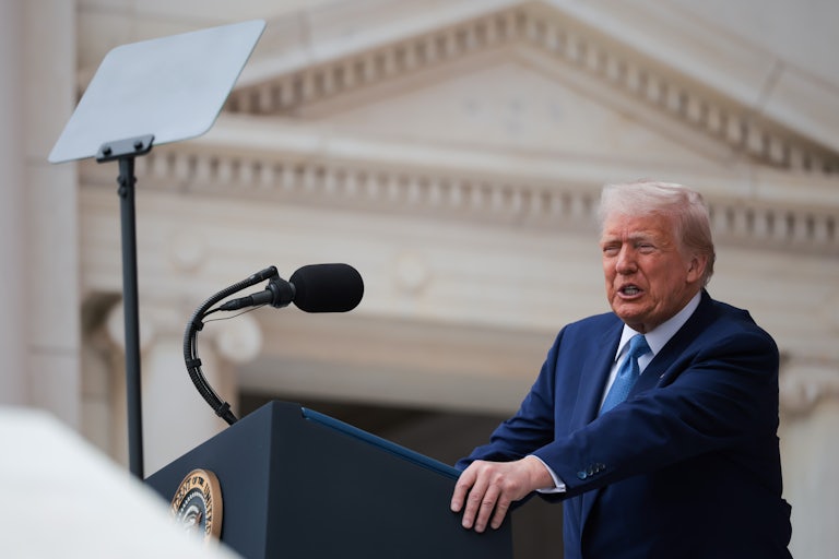 Donald Trump speaks at a podium in Arlington National Cemetery