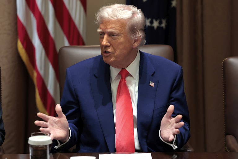 Donald Trump gestures while speaking in a Cabinet meeting