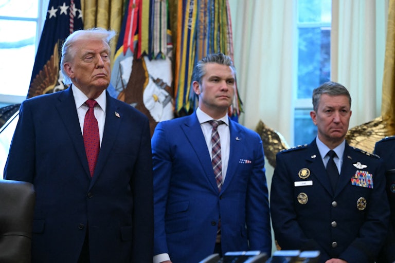 Doanld Trump, Pete Hegseth, and Joint Chiefs of Staff Gen. Dan Caine stand side by side in the Oval Office of the White House.