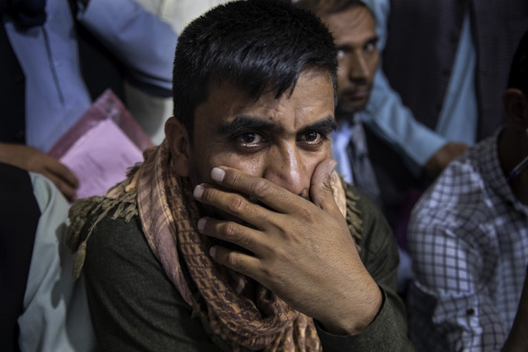 A close-up of an Afghani man, seeking an immigration application.