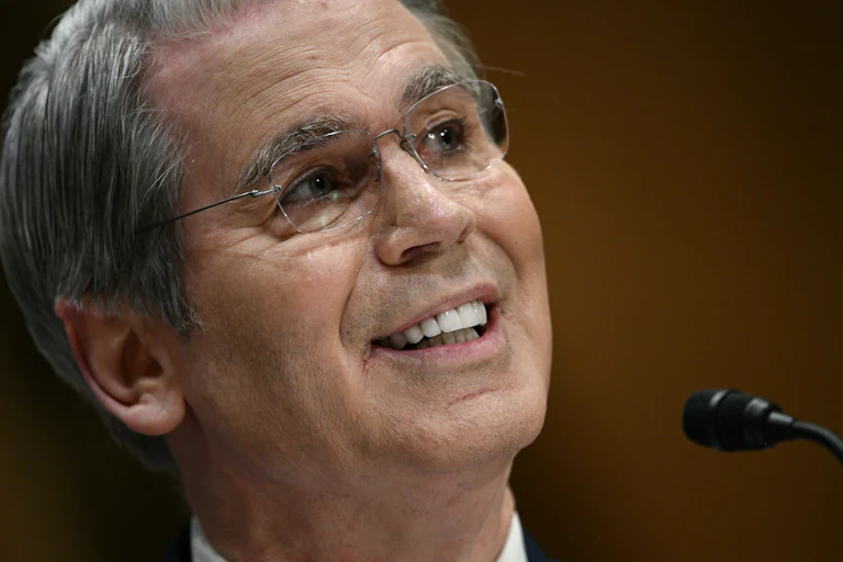 Treasury Secretary Scott Bessent smiles while testifying in a House committee