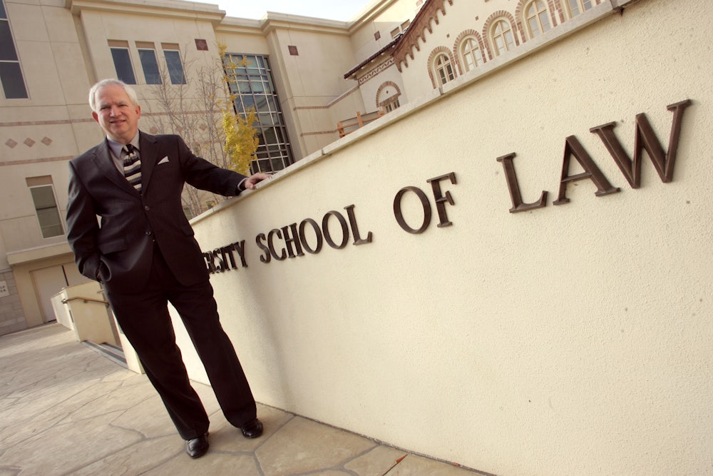 John Eastman poses for a picture outside at Chapman University