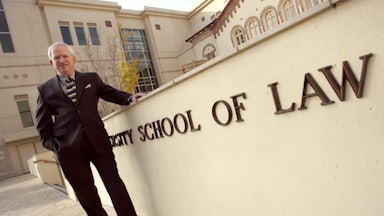 John Eastman poses for a picture outside at Chapman University