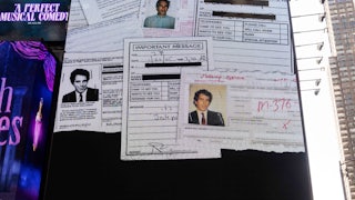 A billboard in Times Square shows random documents with Jeffrey Epstein's face.