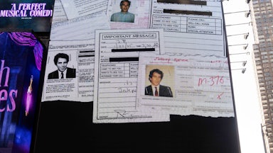 A billboard in Times Square shows random documents with Jeffrey Epstein's face.