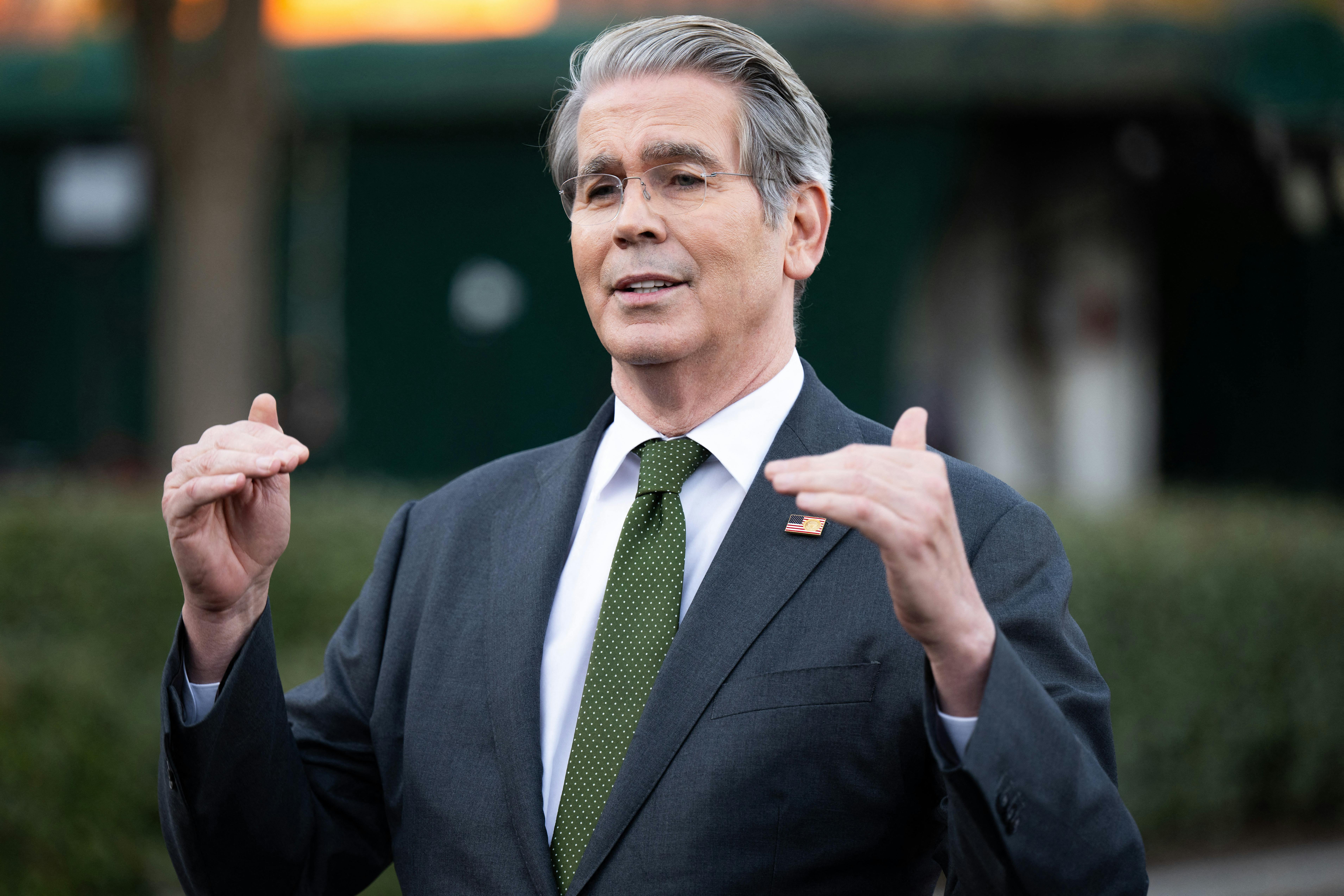 Treasury Secretary Scott Bessent speaks while using both hands to indicate the height of somthing.