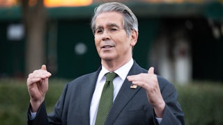 Treasury Secretary Scott Bessent speaks while using both hands to indicate the height of somthing.