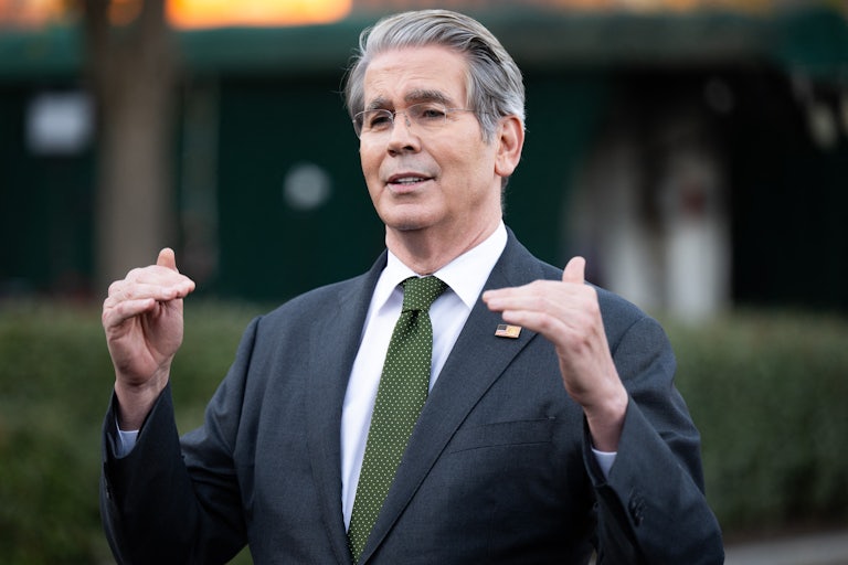 Treasury Secretary Scott Bessent speaks while using both hands to indicate the height of somthing.