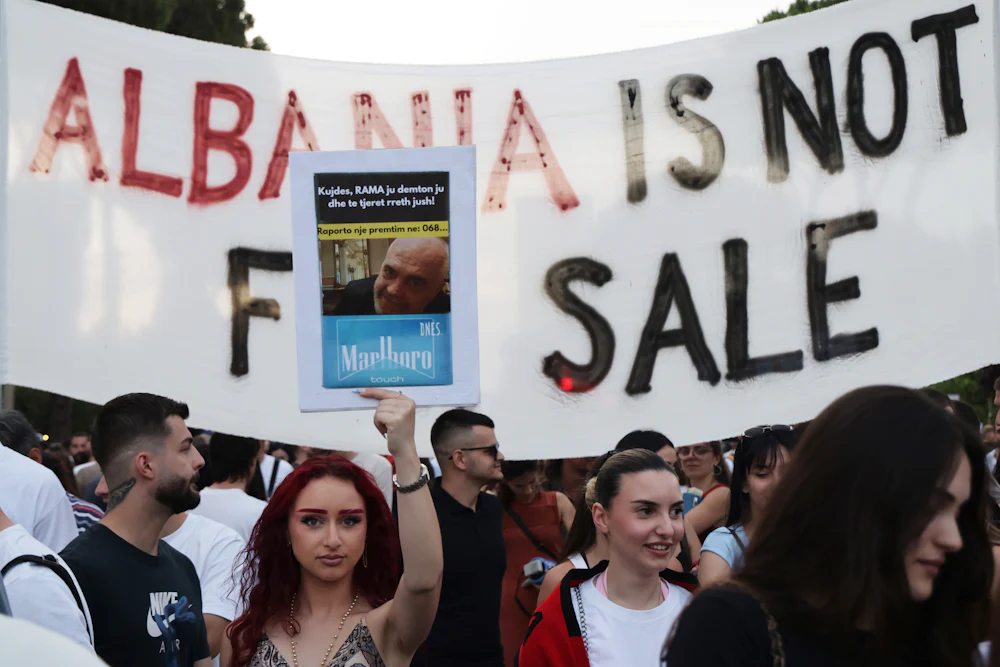 On June 14, demonstrators held up signs as they protested in Tirana, Albania, against a proposed luxury tourism development project associated with Jared Kushner. One sign reads "Albania is not for sale."