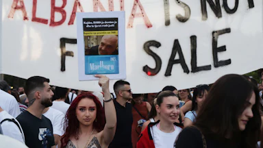 On June 14, demonstrators held up signs as they protested in Tirana, Albania, against a proposed luxury tourism development project associated with Jared Kushner. One sign reads "Albania is not for sale."