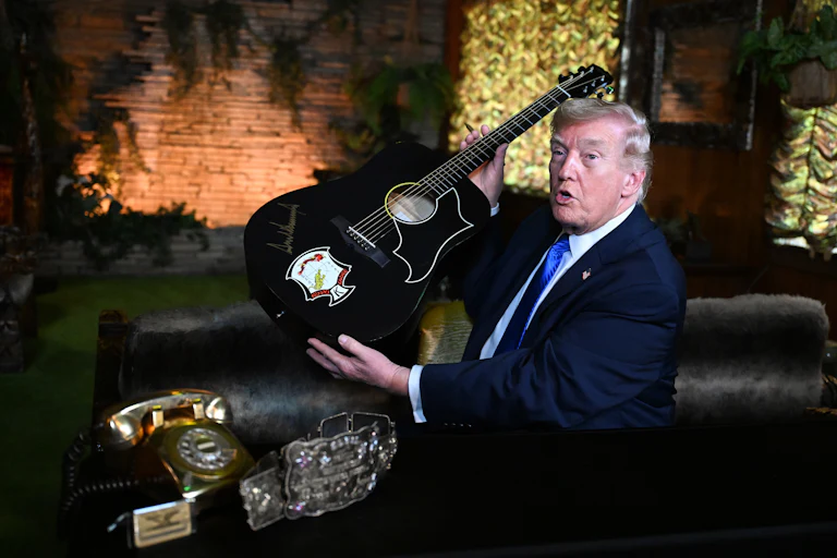 Donald trump holds an acoustic guitar
