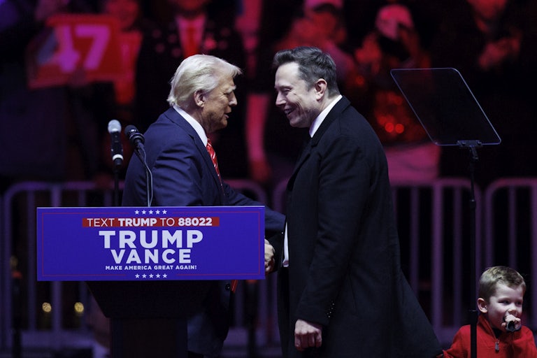 Donald Trump and Elon Musk smile and shake hands on stage