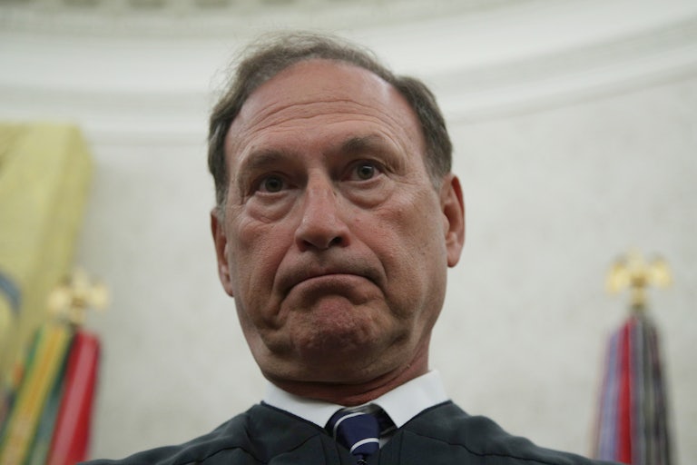 A close-up of a grimacing Supreme Court Justice Samuel Alito.