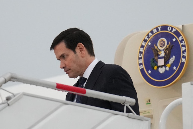 Secretary of State Marco Rubio exits a plane in Mexico City.