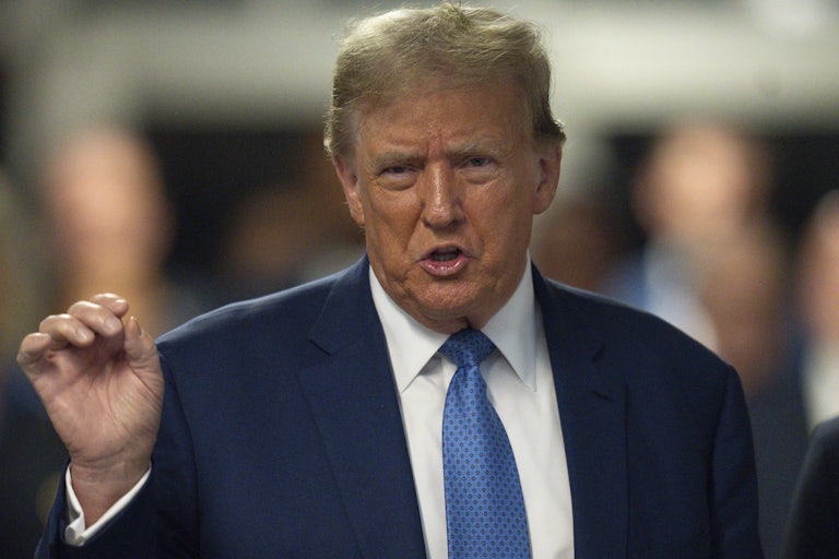 Donald Trump speaks and gestures with his right hand