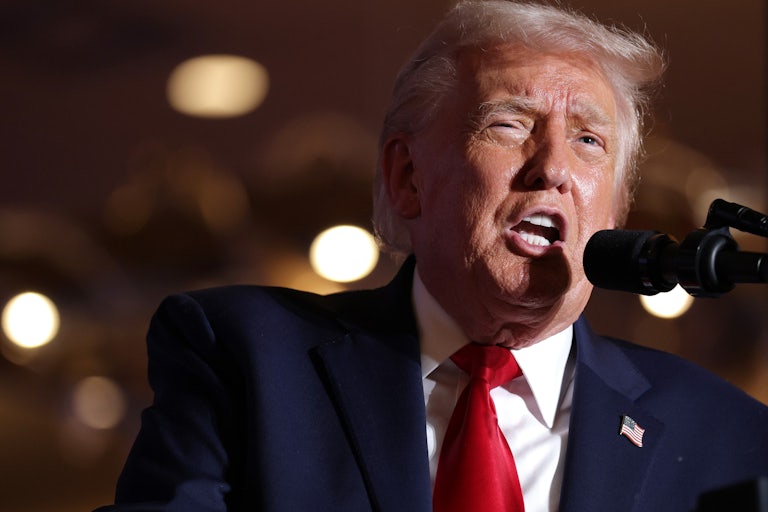 Donald Trump speaks into a mic