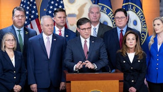 House Speaker Mike Johnson speaks at a podium while flanked by other Republican representatives