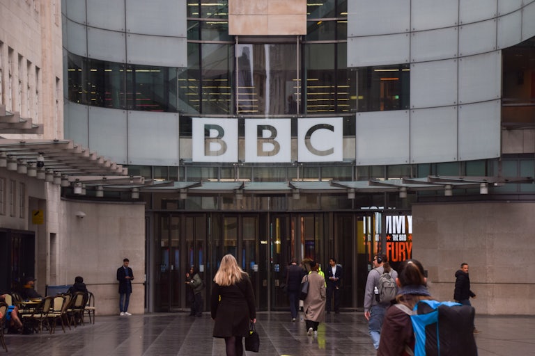 People walk outside the BBC headquarters in London.