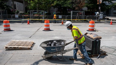 Construction workers repairs a street near the White House, in Washington, DC.