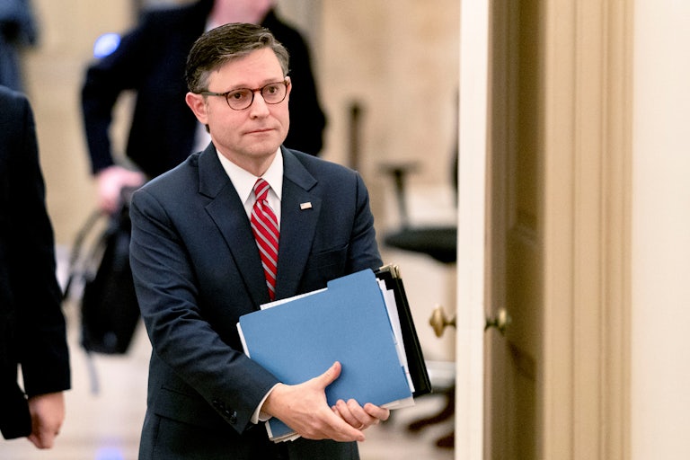 Mike Johnson walks in the Capitol